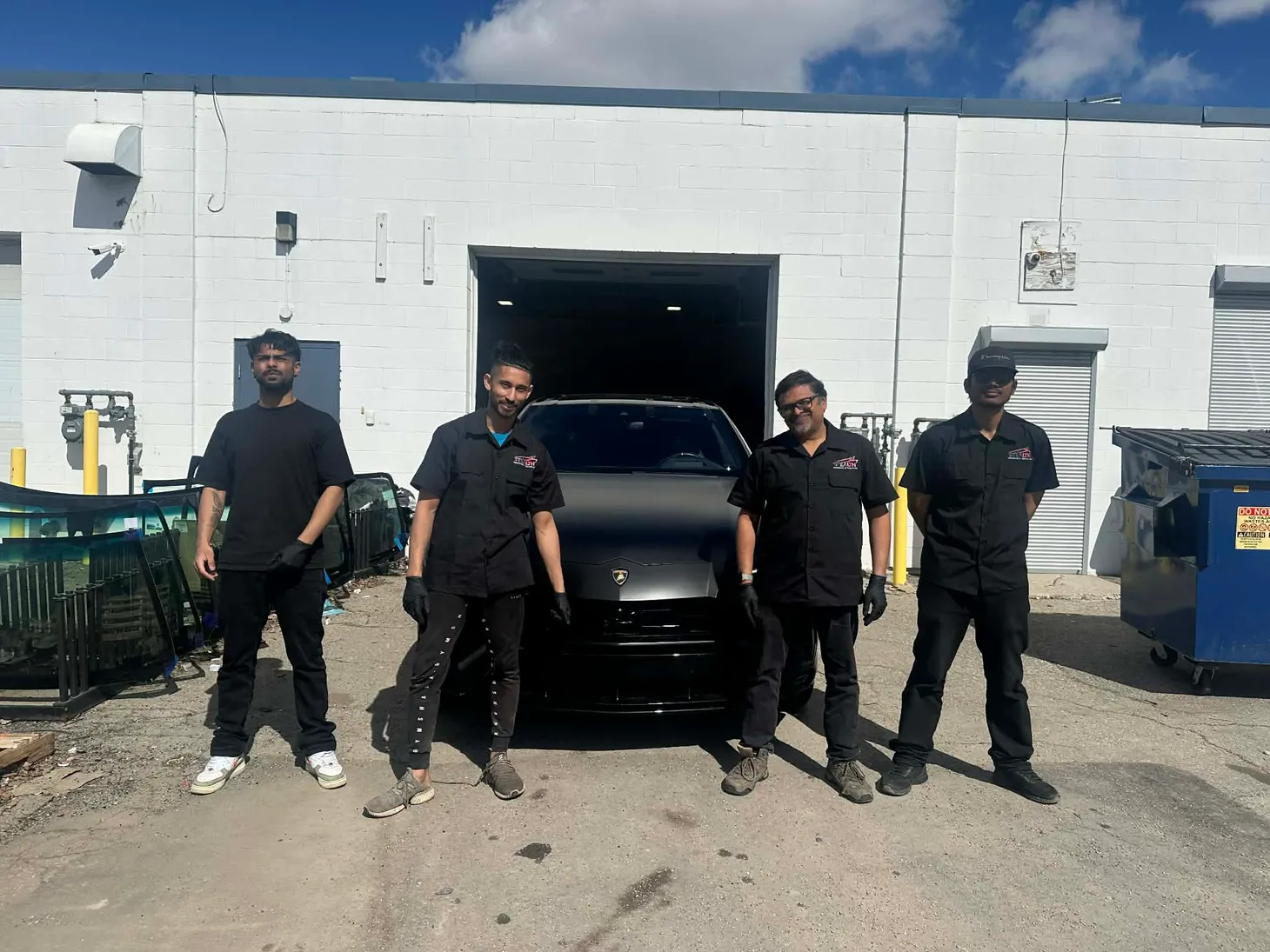 Four of Stealth's crew members just finished working on a beautiful matt black Lamborghini Urus SUV