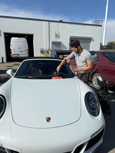 Beautiful white Porsche Cayman undergoing a front windshield chip repair at Stealth Windshield Repair