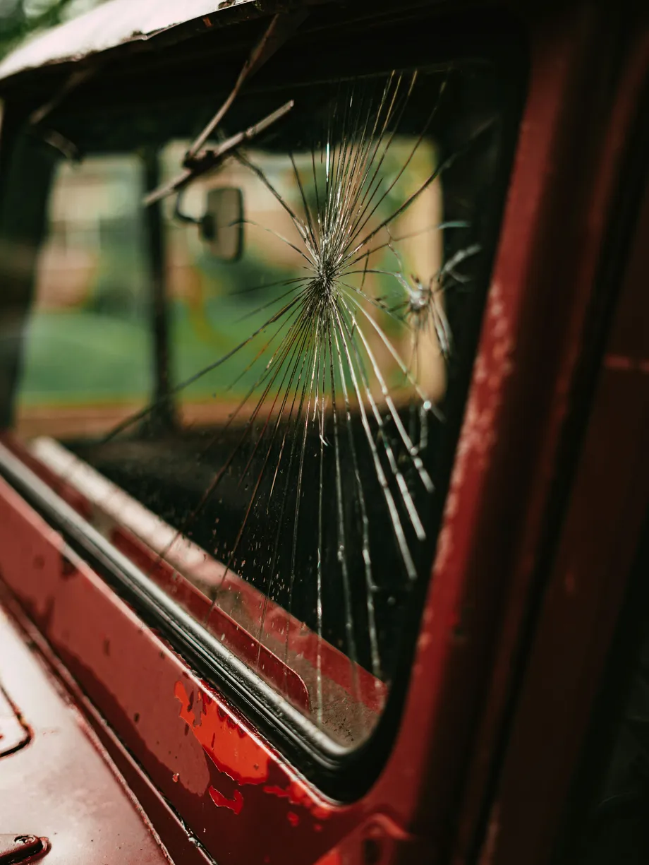 Cracked side-windshield of a red bus