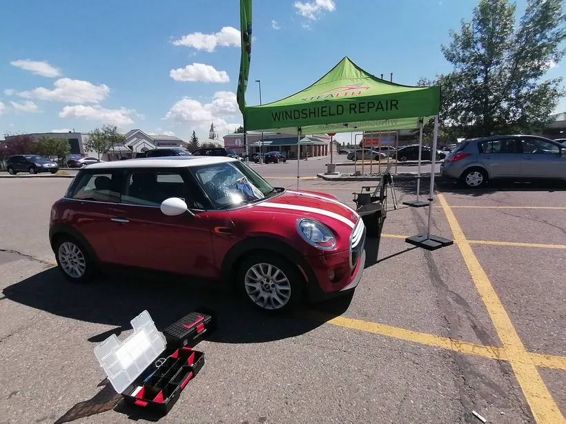 A Cooper Hardtop in the middle of windshield chip repair at one of our Stealth Windshield Repair tents in Calgary, Alberta